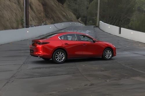 Mazda 3 Sedan side view in red color